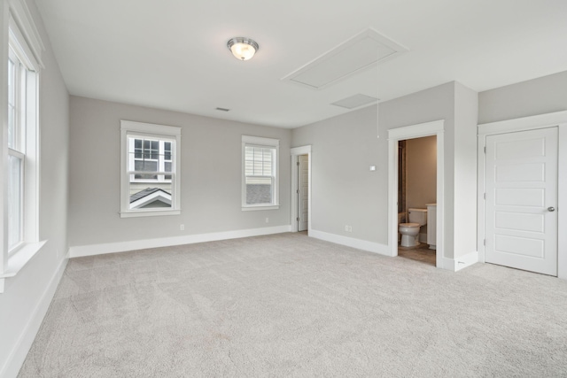 spare room featuring light colored carpet