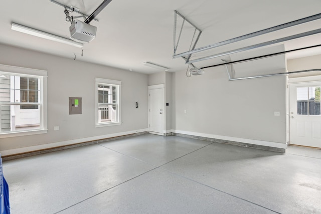 garage with electric panel and a garage door opener