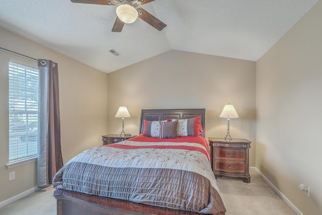 bedroom featuring baseboards, visible vents, a ceiling fan, vaulted ceiling, and carpet floors