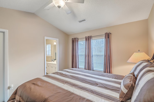 bedroom with lofted ceiling, ceiling fan, a textured ceiling, and visible vents