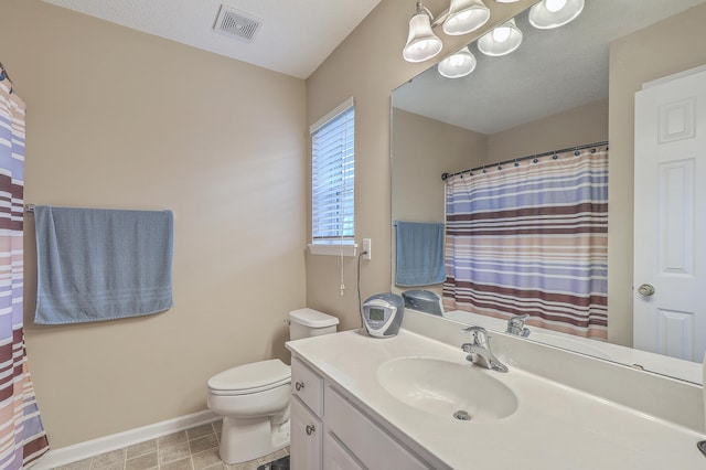 bathroom with curtained shower, visible vents, toilet, vanity, and baseboards