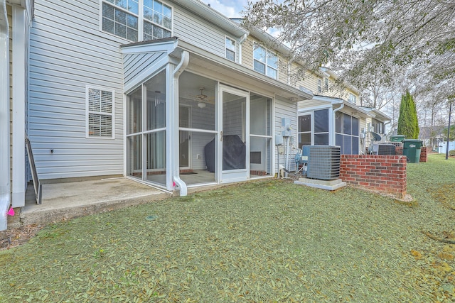 back of house with a sunroom, central AC, and a yard