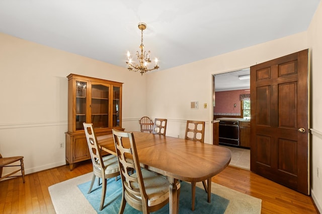 dining room featuring a notable chandelier and light hardwood / wood-style floors