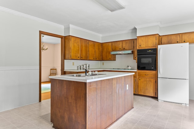 2266 Griffith Dr, Orangeburg, SC 29118 - kitchen featuring freestanding refrigerator, black oven, light countertops, under cabinet range hood, and brown cabinets