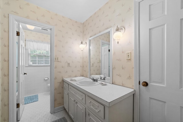 bathroom with vanity, toilet, and tile patterned floors