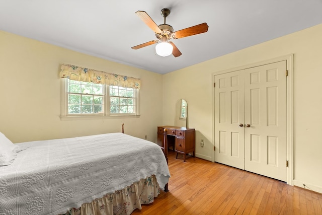 bedroom featuring ceiling fan, light hardwood / wood-style flooring, and a closet