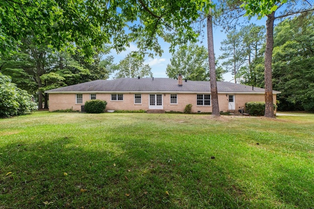 back of property featuring a yard