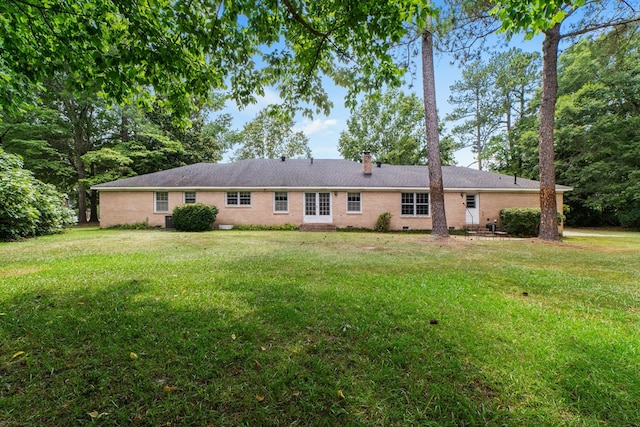 2266 Griffith Dr, Orangeburg, SC 29118 - rear view of property with a yard, brick siding, and a chimney