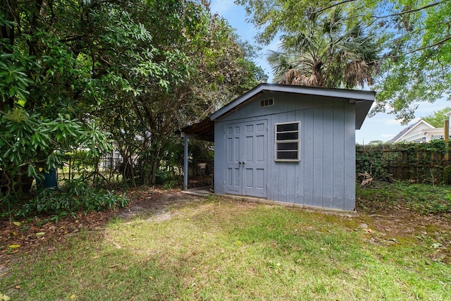 view of outdoor structure featuring a lawn