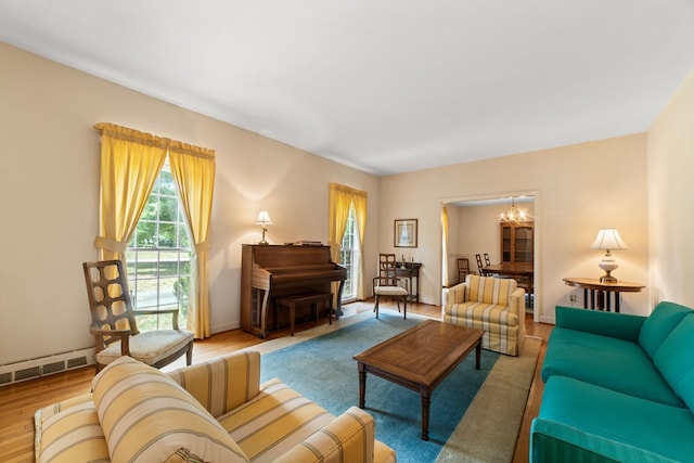 living room with a notable chandelier and light hardwood / wood-style floors