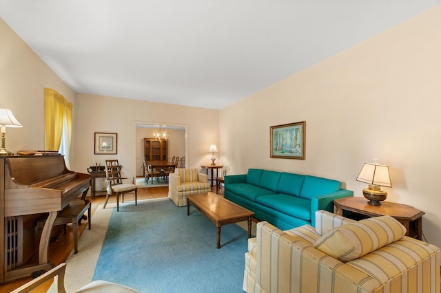 carpeted living room featuring a chandelier