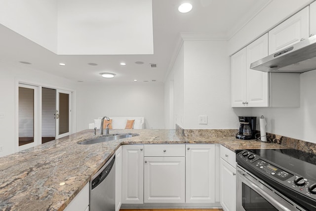 kitchen featuring white cabinets, a sink, stone counters, visible vents, and crown molding