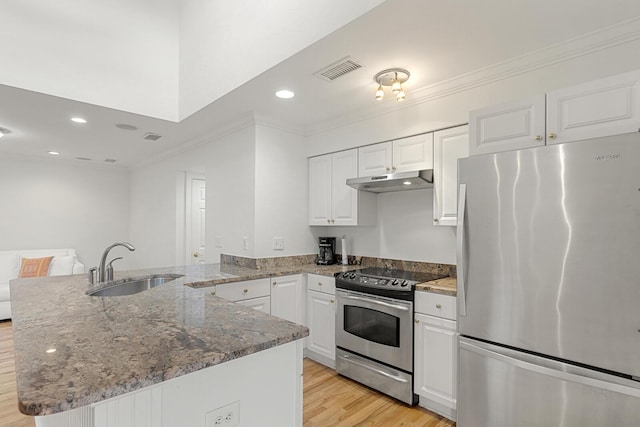 kitchen with recessed lighting, crown molding, a sink, and stone counters
