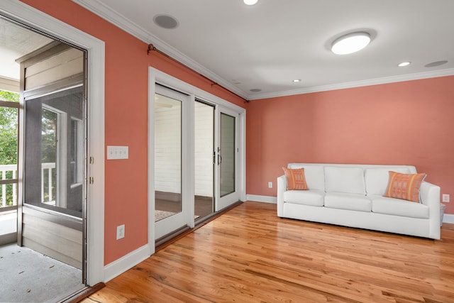 unfurnished living room featuring light hardwood / wood-style flooring and ornamental molding