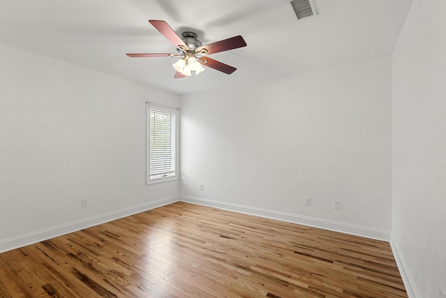unfurnished bedroom featuring light wood finished floors, baseboards, ensuite bath, and visible vents