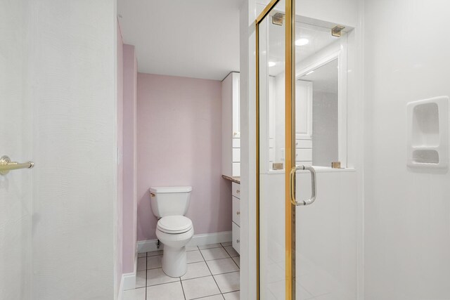 bathroom with an enclosed shower, vanity, tile patterned floors, and toilet