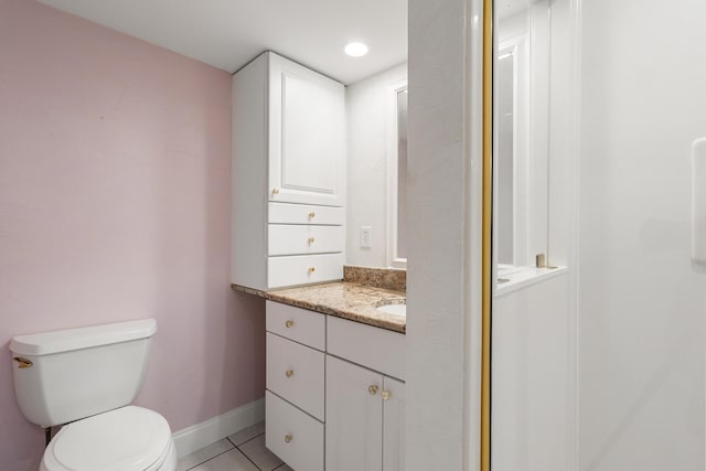 bathroom featuring tile patterned floors, toilet, and vanity