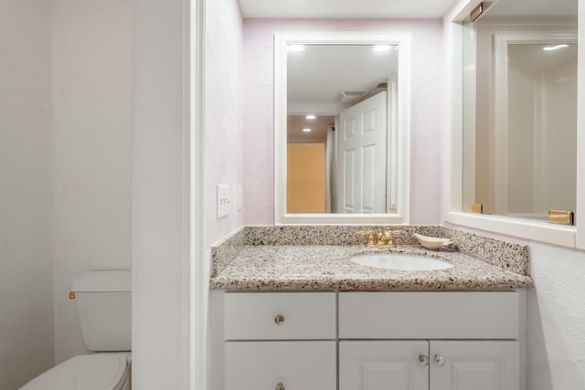 bathroom with vanity and toilet