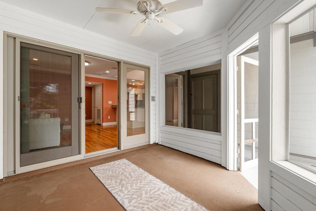 sunroom / solarium featuring ceiling fan