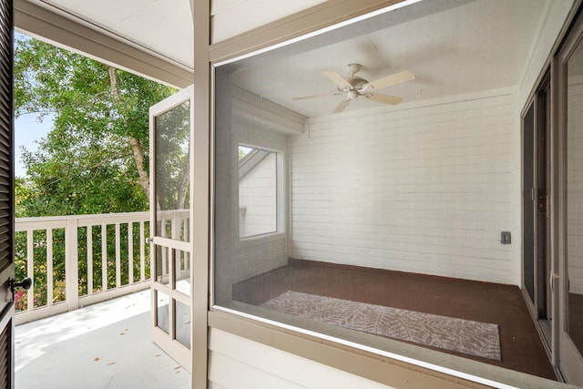 unfurnished sunroom with ceiling fan and a healthy amount of sunlight