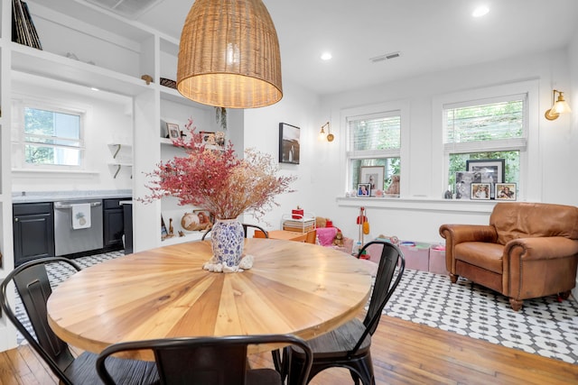 dining space with hardwood / wood-style flooring and recessed lighting