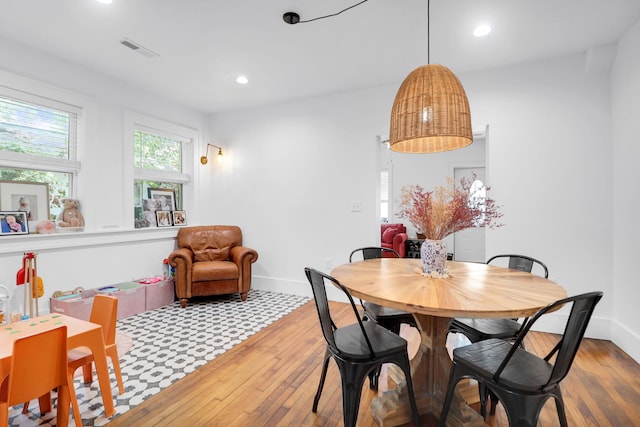 dining space featuring wood-type flooring, recessed lighting, and baseboards