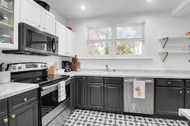 kitchen featuring stainless steel appliances, a sink, white cabinetry, open shelves, and recessed lighting