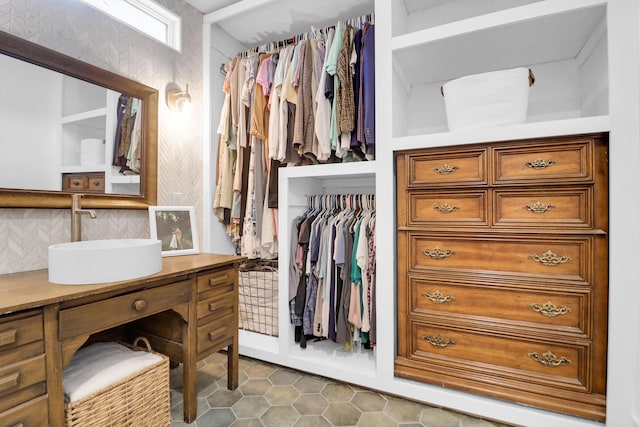 spacious closet with a sink and tile patterned floors