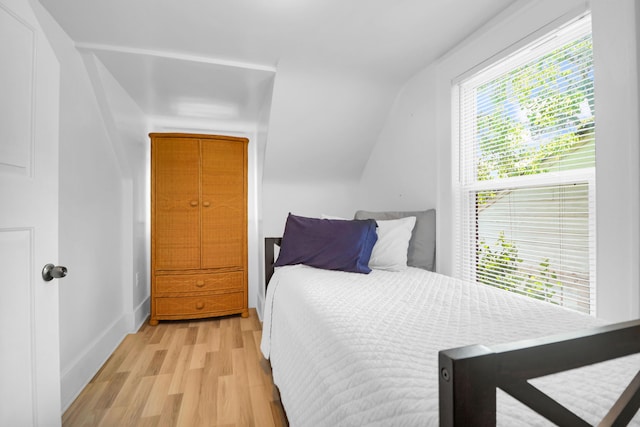bedroom featuring light wood-style flooring and baseboards