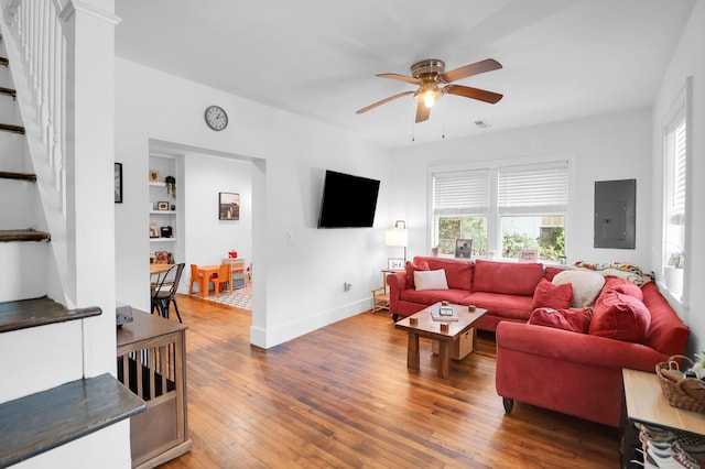 living room featuring electric panel, ceiling fan, healthy amount of natural light, and hardwood / wood-style floors