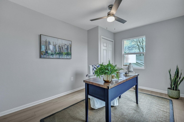 office space with ceiling fan, baseboards, and wood finished floors