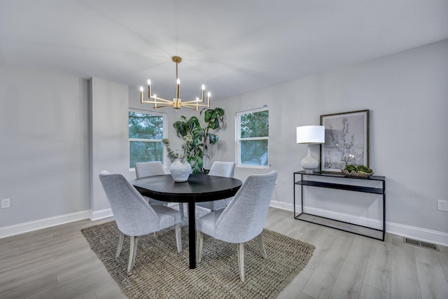 dining space with a wealth of natural light, wood finished floors, and visible vents