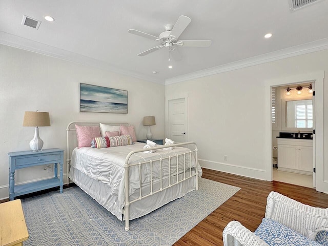 bedroom featuring ornamental molding, dark wood-style flooring, a sink, and visible vents