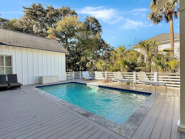 view of swimming pool featuring a fenced in pool and a deck