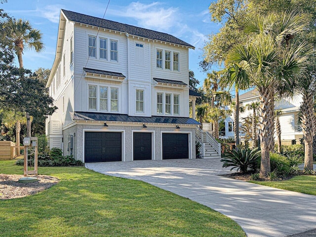 beach home with metal roof, a garage, stairway, a front lawn, and a standing seam roof