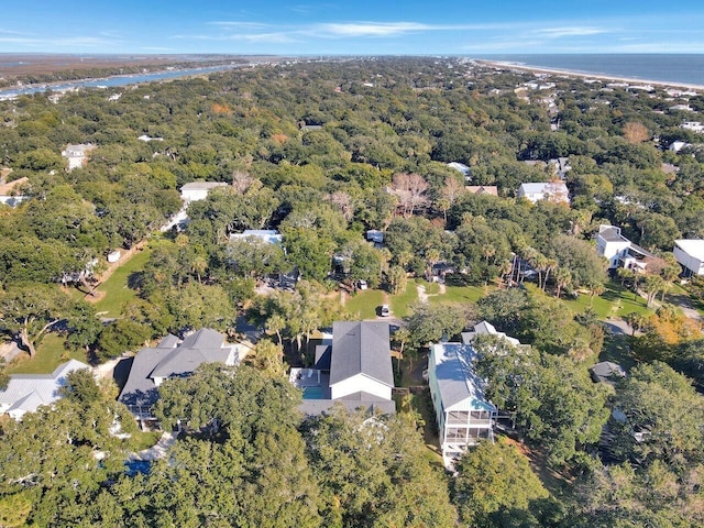 drone / aerial view with a water view, a residential view, and a view of trees