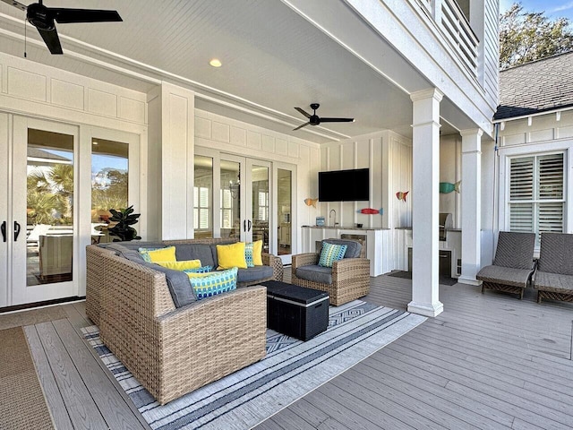 wooden terrace with ceiling fan and outdoor lounge area