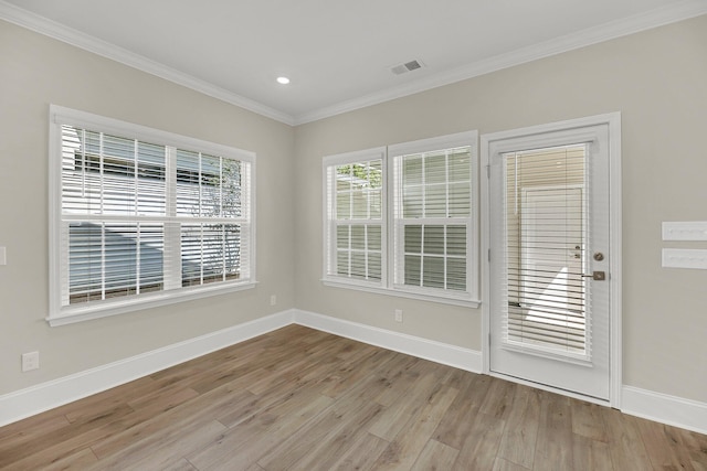 unfurnished room featuring crown molding and light hardwood / wood-style flooring