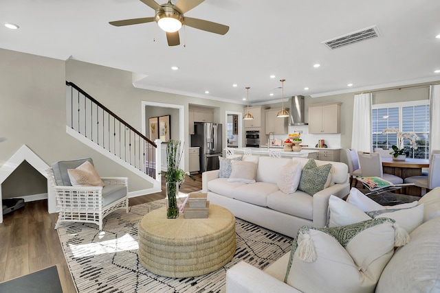 living room featuring crown molding, sink, hardwood / wood-style flooring, and ceiling fan