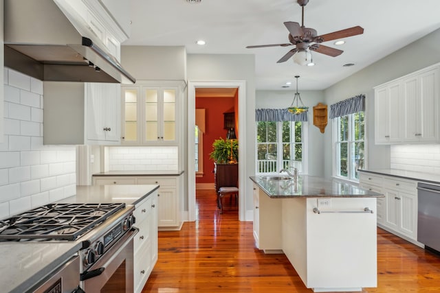 707 Royall Ave, Mount Pleasant, SC 29464 - kitchen featuring a ceiling fan, dark stone countertops, a sink, under cabinet range hood, and appliances with stainless steel finishes