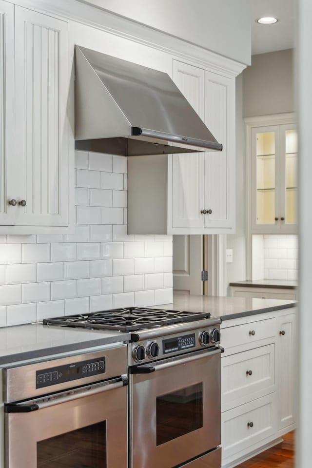 707 Royall Ave, Mount Pleasant, SC 29464 - kitchen with recessed lighting, white cabinetry, backsplash, range hood, and appliances with stainless steel finishes