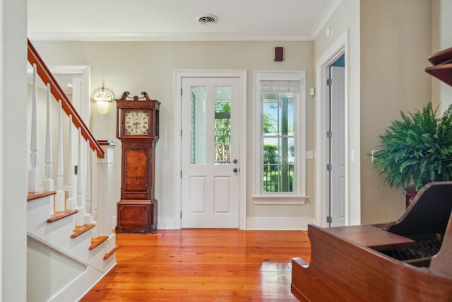 707 Royall Ave, Mount Pleasant, SC 29464 - foyer entrance with stairway, light wood finished floors, crown molding, and visible vents