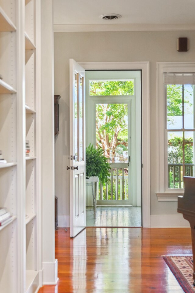 707 Royall Ave, Mount Pleasant, SC 29464 - doorway with crown molding, baseboards, visible vents, and wood finished floors