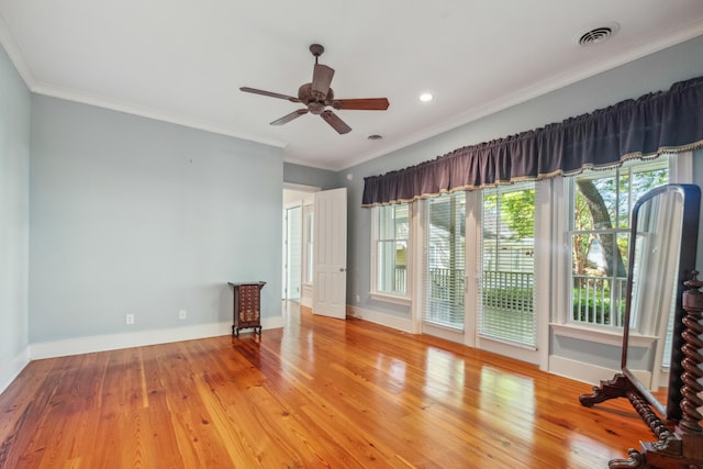 707 Royall Ave, Mount Pleasant, SC 29464 - unfurnished living room featuring wood finished floors, ornamental molding, visible vents, a ceiling fan, and baseboards