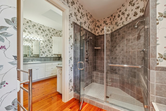707 Royall Ave, Mount Pleasant, SC 29464 - bathroom featuring vanity, a shower stall, wallpapered walls, and wood finished floors