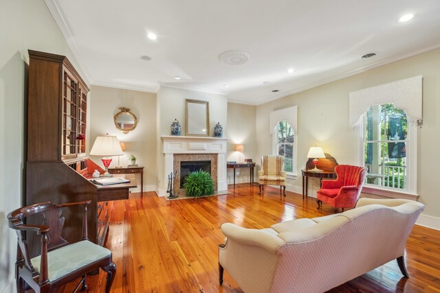 707 Royall Ave, Mount Pleasant, SC 29464 - living area with ornamental molding, a fireplace with flush hearth, recessed lighting, and wood finished floors