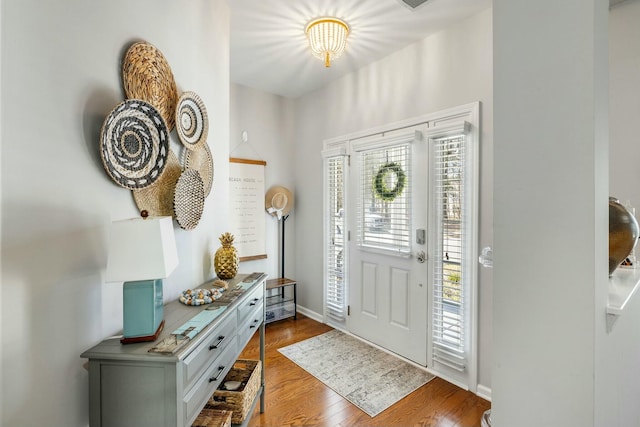 foyer featuring wood finished floors and baseboards