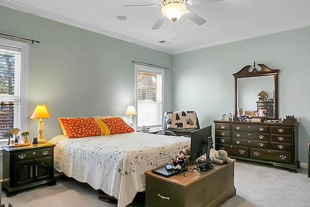 carpeted bedroom with ceiling fan and crown molding