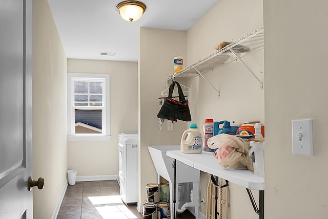 laundry area featuring tile patterned flooring and washer / clothes dryer