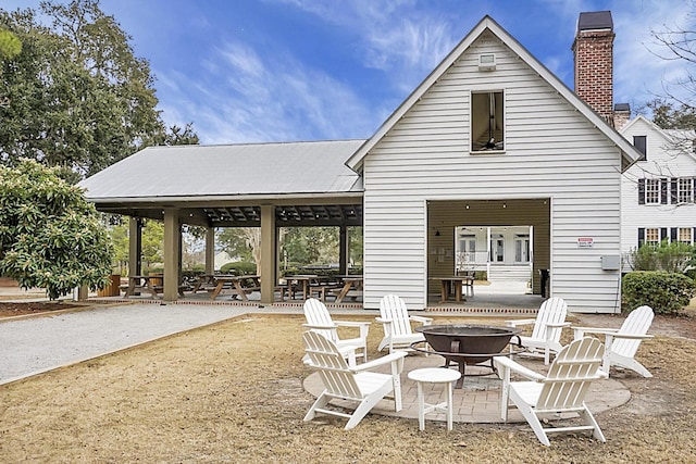 exterior space with an outdoor fire pit and a patio